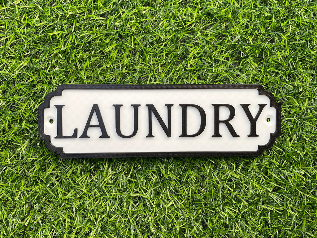 White and black classic door sign reading Laundry