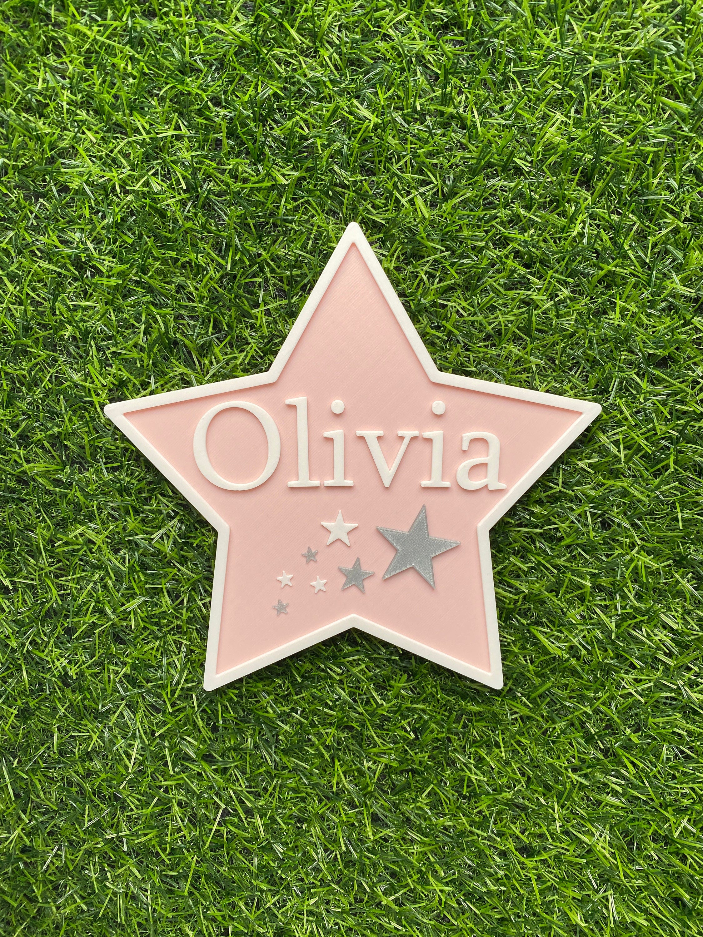 Pastel pink star door sign with silver stars and the name Olivia