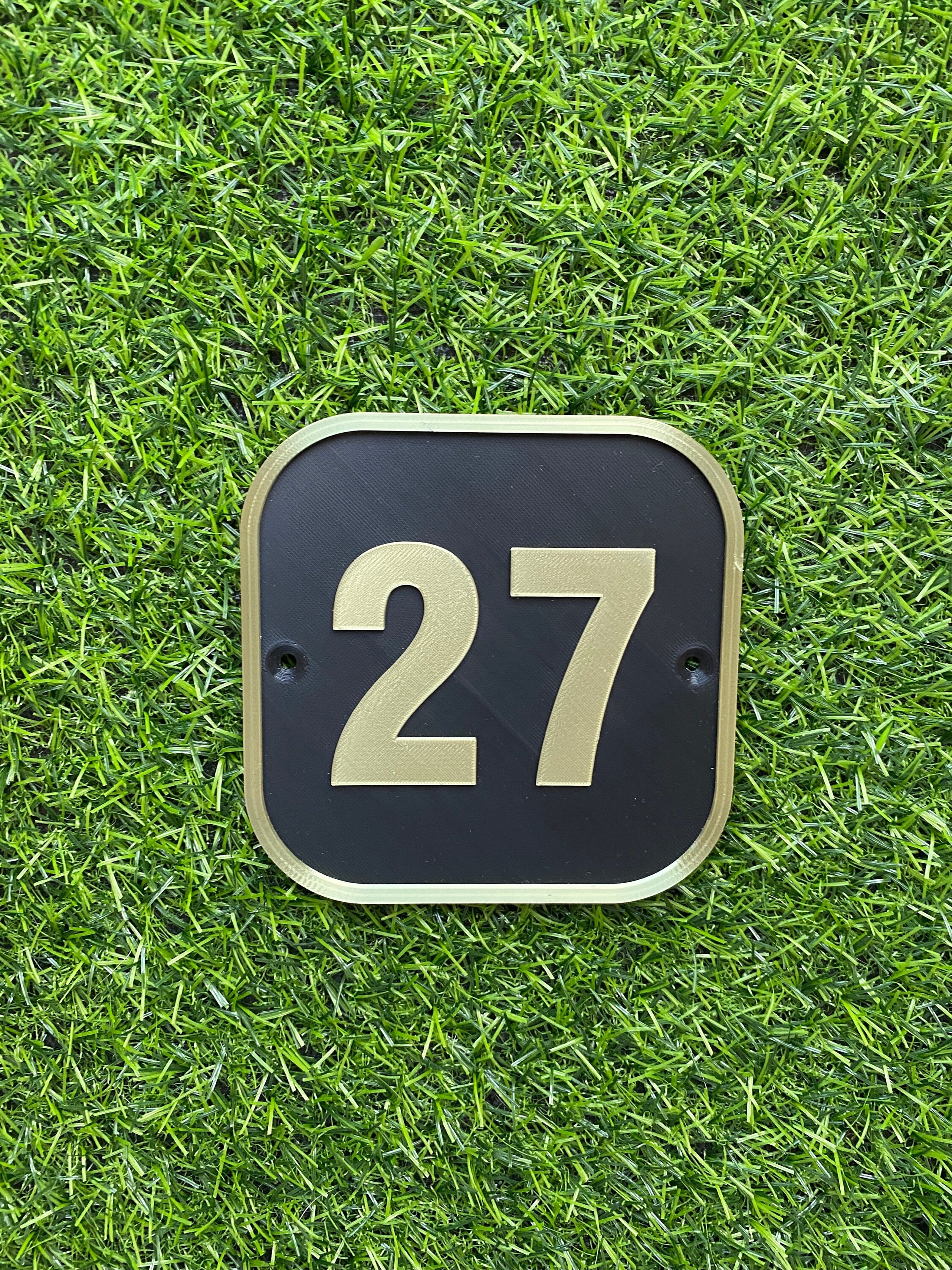 Black and gold square house door number 27