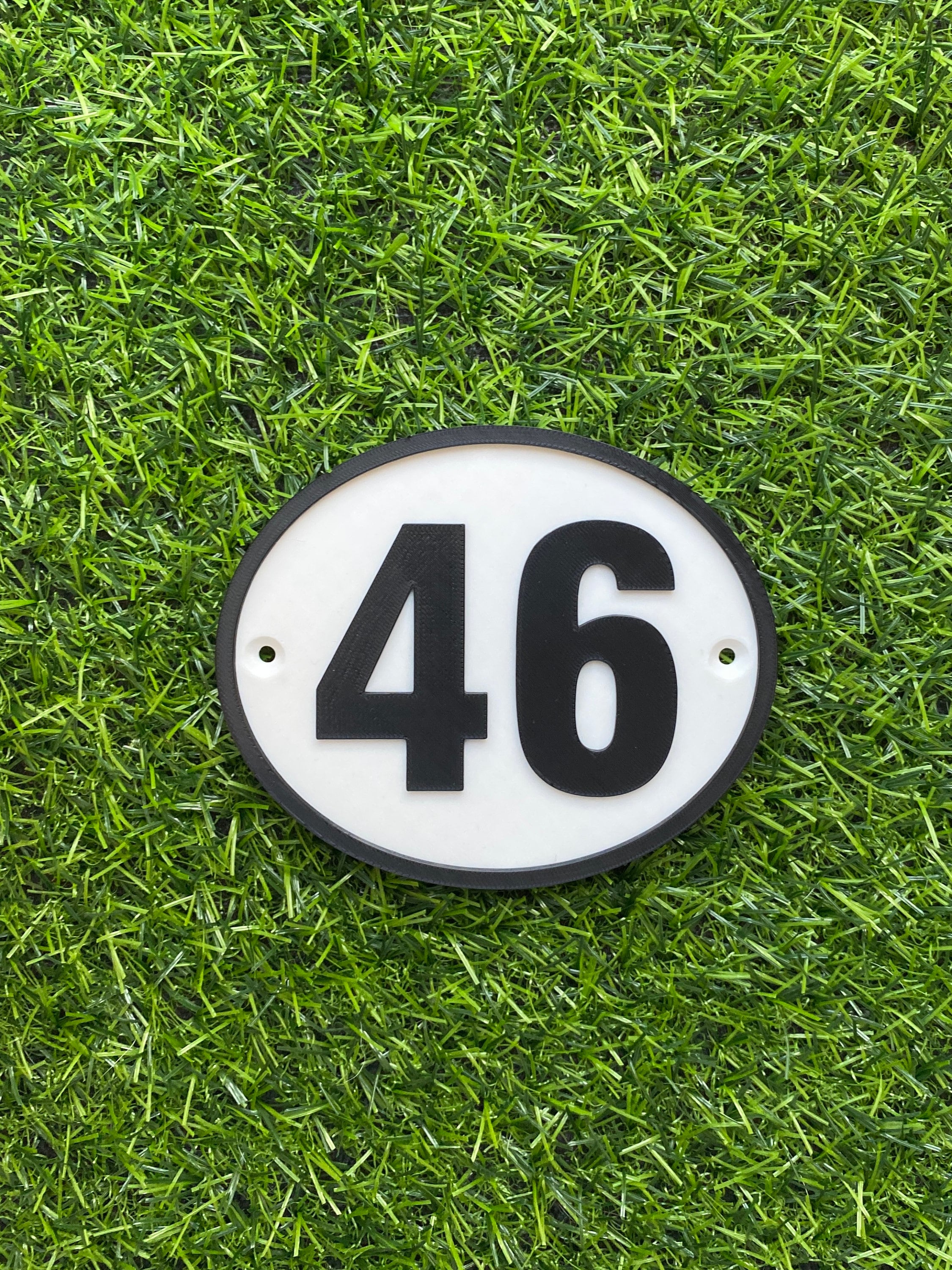 Personalised oval house door number sign in black and white