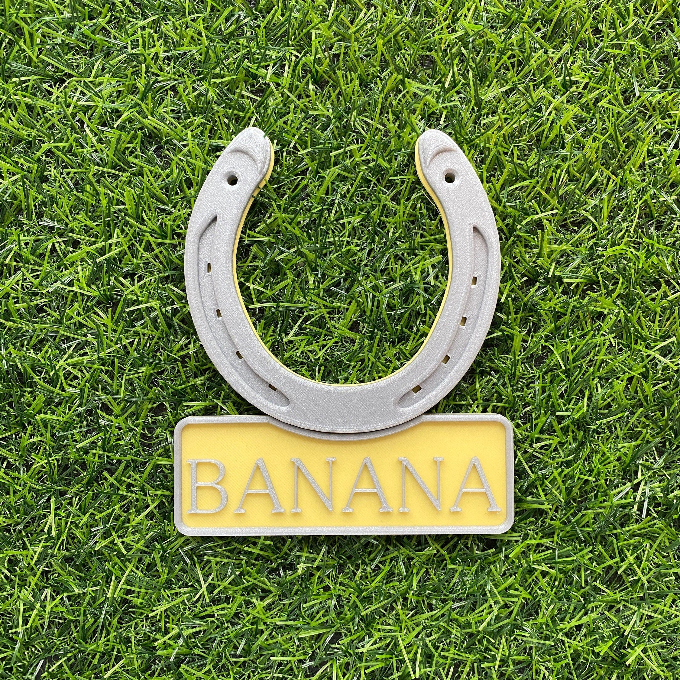 Yellow personalised horseshoe name plate with a silver horseshoe, name Banana