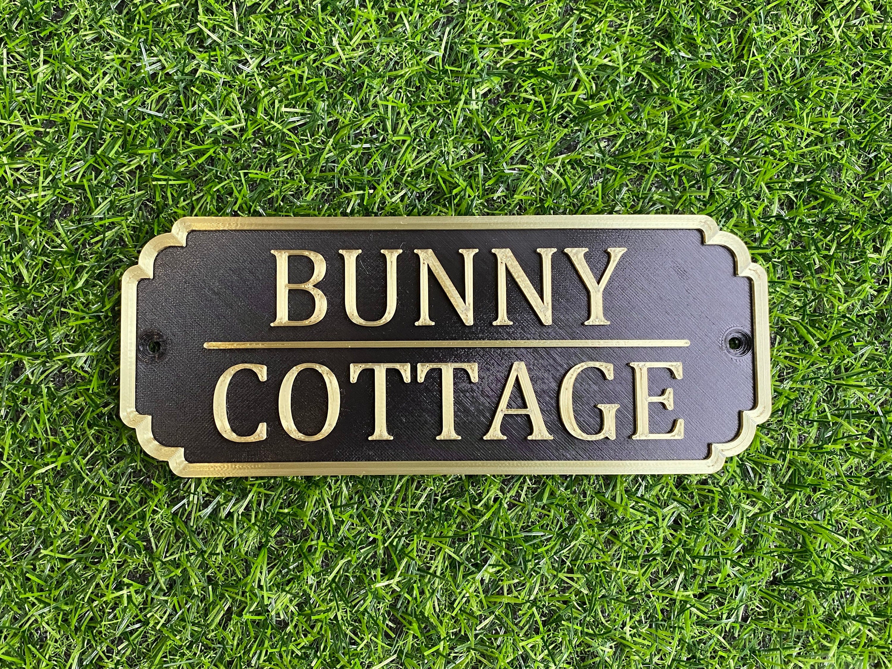Black and gold rabbit hutch sign reading Bunny Cottage
