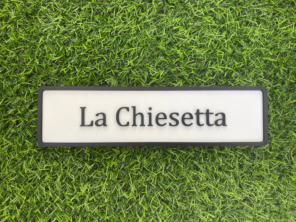 White and black contemporary door sign reading La Chiesetta
