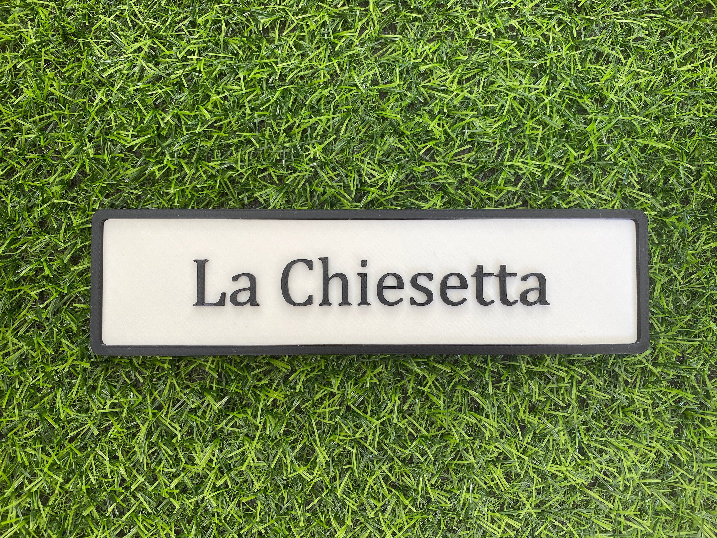 White and black contemporary door sign reading La Chiesetta