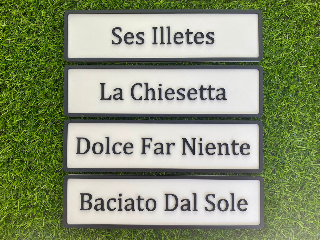 Four contemporary door signs stacked: Ses Illetes, La Chiesetta, Dolce Far Niente and Baciato Dal Sole