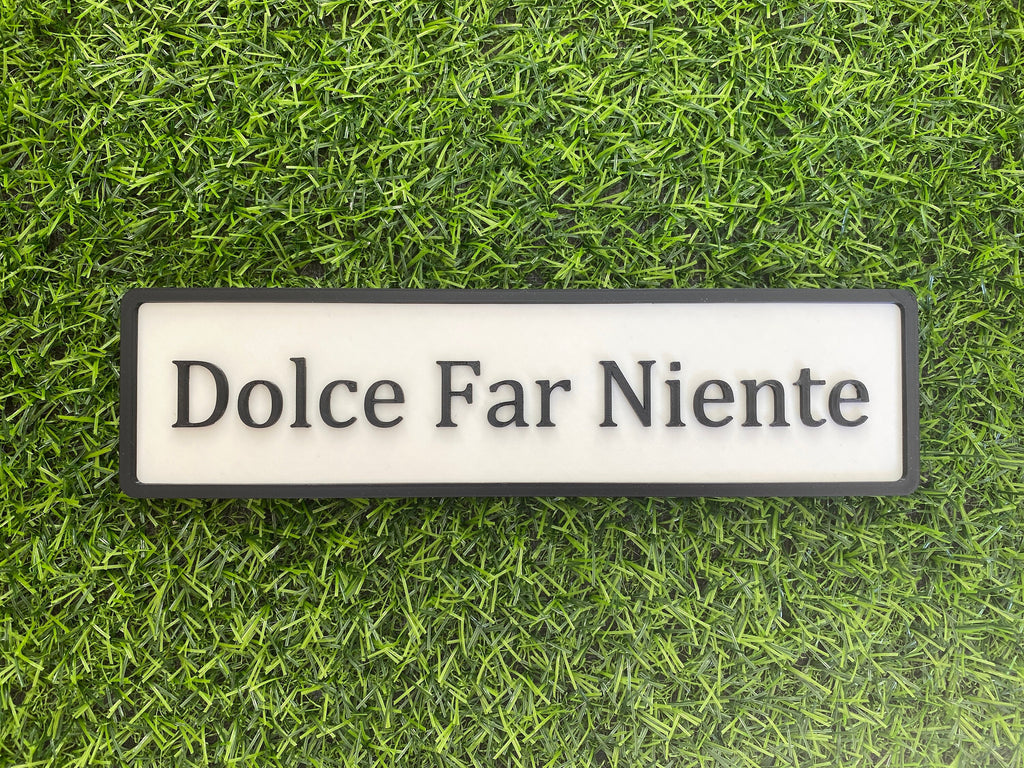 White and black contemporary door sign reading Dolce Far Niente