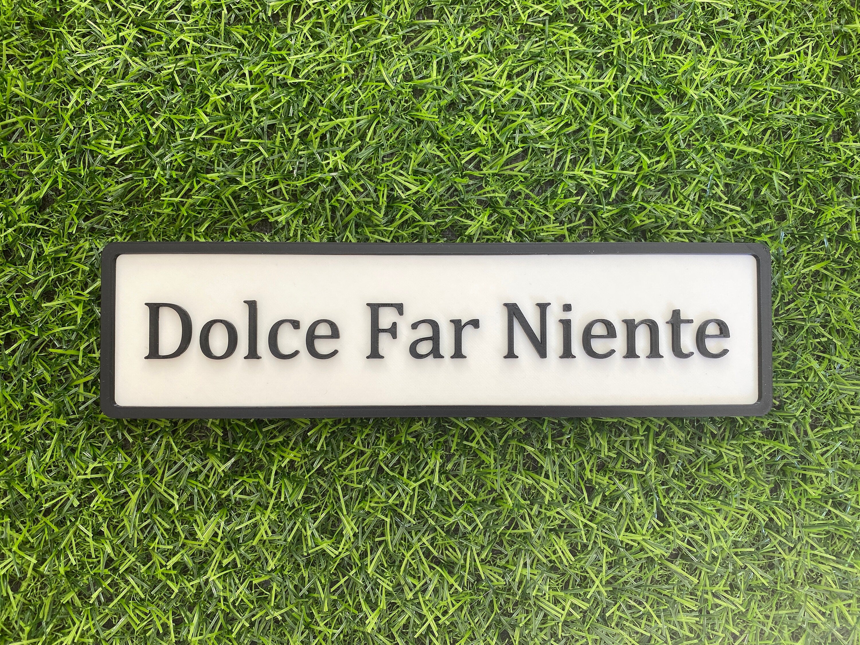 White and black contemporary door sign reading Dolce Far Niente