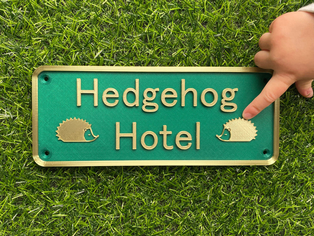 Green and gold Hedgehog Hotel sign with hedgehog motifs