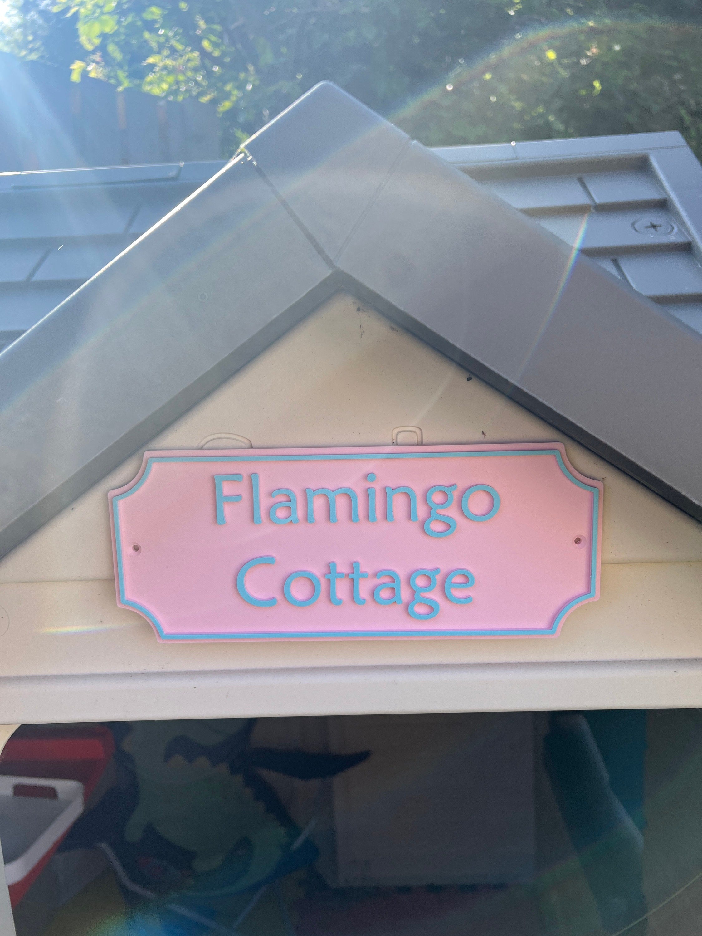 Flamingo Cottage Emley sign fitted to the gable of a playhouse