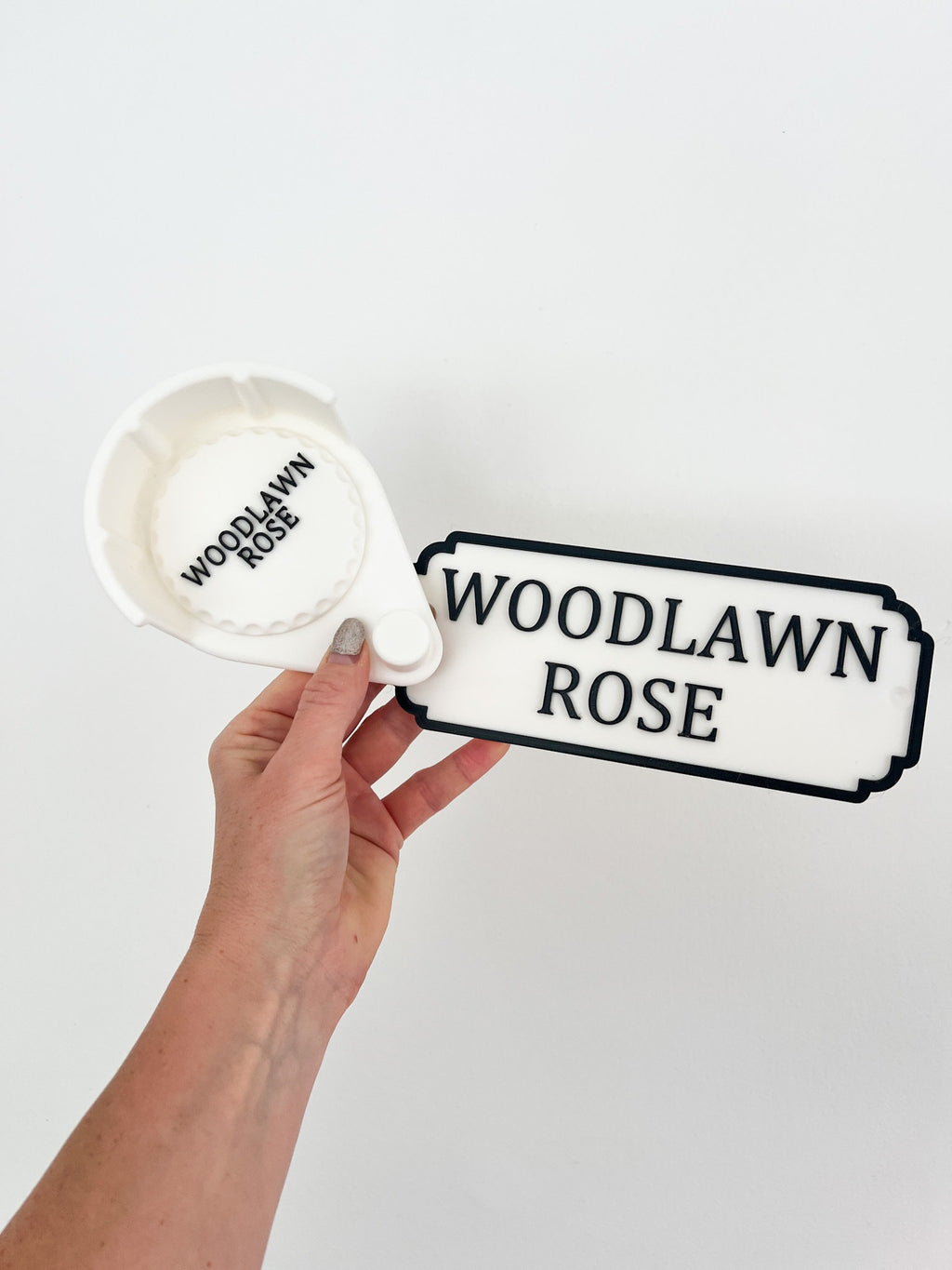White personalised bridle holder held in hand with nameplate reading Woodlawn Rose