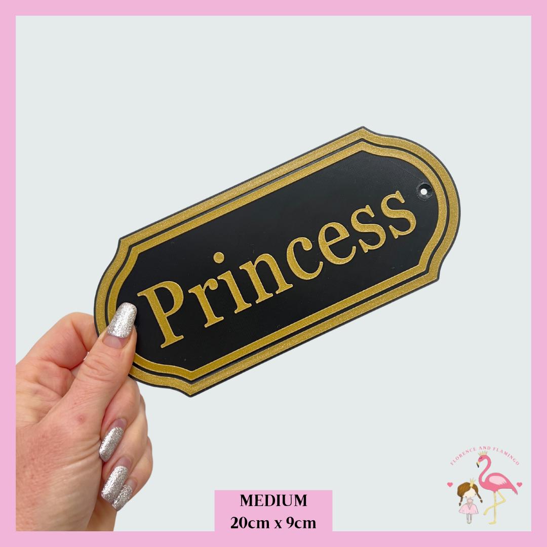 Medium Traditional name plate in black and gold reading Princess, 20cm x 9cm
