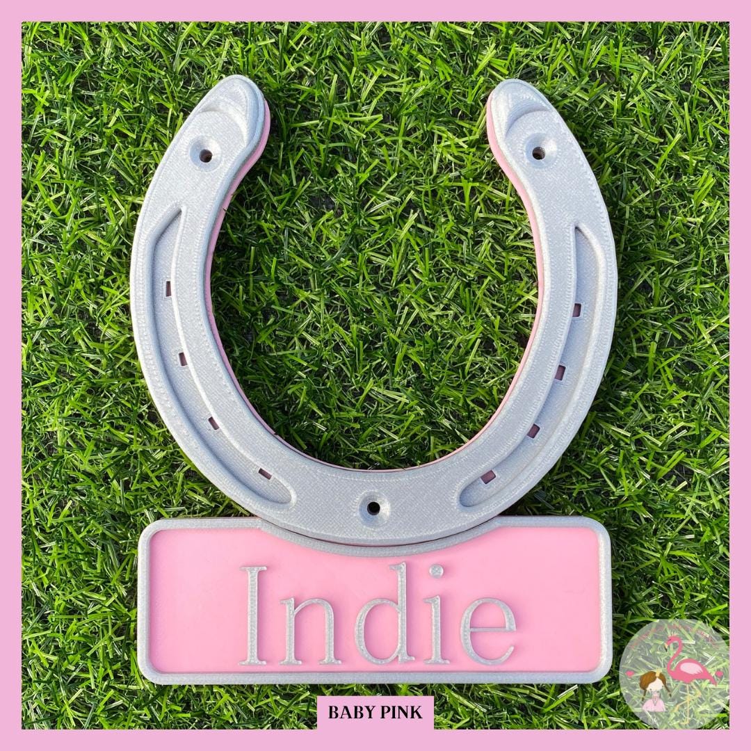 Personalised horseshoe stable door name plate in baby pink with a silver horseshoe, name Indie