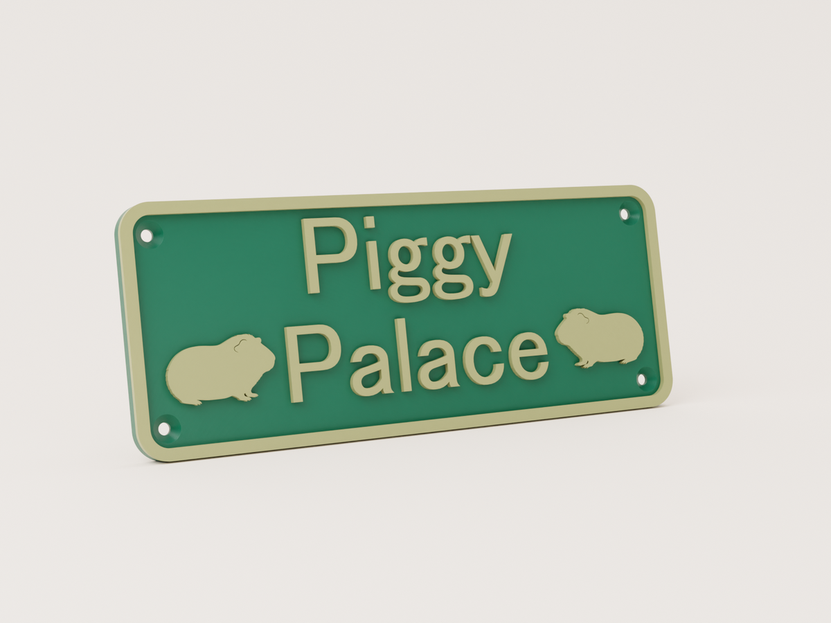 Guinea pig house sign seen from an angle, showing the raised lettering and screw holes