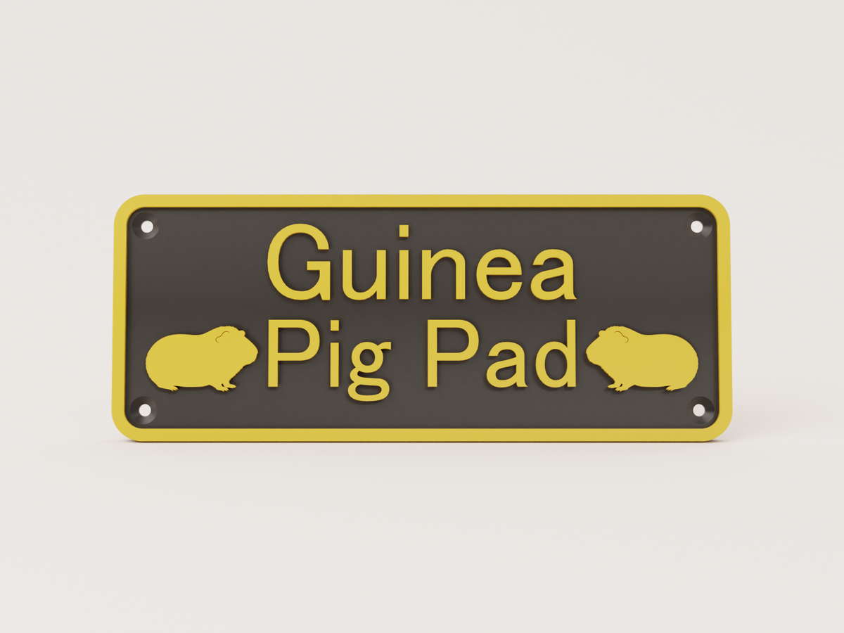 Black guinea pig house sign with gold lettering reading Guinea Pig Pad